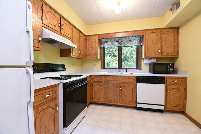 10278 SW Hwy Unit 1D, Chicago Ridge, IL 60415 - kitchen with white appliances, under cabinet range hood, brown cabinets, and light countertops