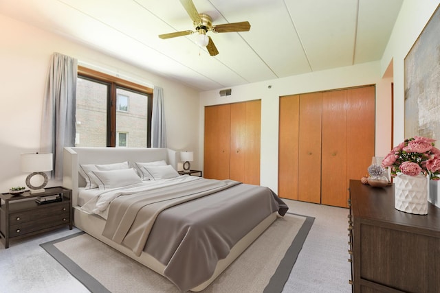 10278 SW Hwy Unit 1D, Chicago Ridge, IL 60415 - bedroom with two closets, light colored carpet, and ceiling fan
