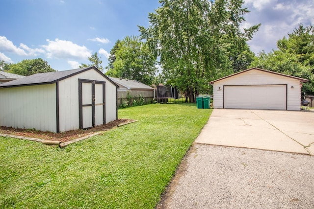 8322 Laporte Ave, Burbank, IL 60459 - view of green lawn with a trampoline, a garage, and a storage unit