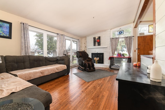 144 Crestwood Dr, East Dundee, IL 60118 - living area with lofted ceiling, wood finished floors, and a stone fireplace