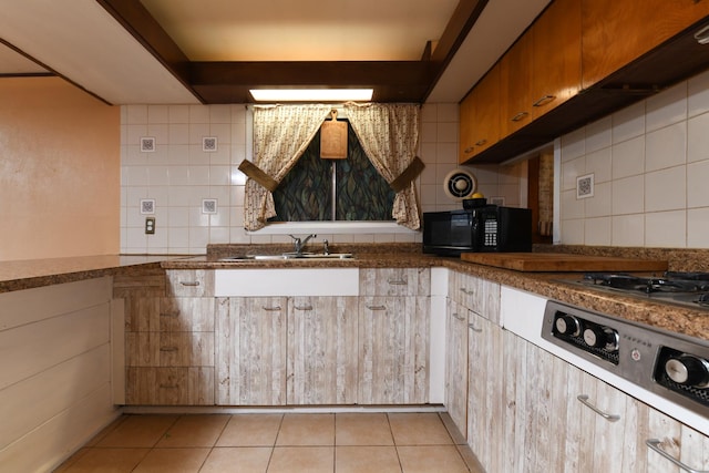 144 Crestwood Dr, East Dundee, IL 60118 - kitchen with black microwave, tasteful backsplash, dark countertops, and light tile patterned floors