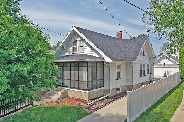 623 Marcy St, Ottawa, IL 61350 - back of property featuring a sunroom, a shingled roof, and a chimney