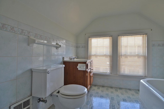 623 Marcy St, Ottawa, IL 61350 - full bath featuring tile walls, vanity, a tub to relax in, and vaulted ceiling
