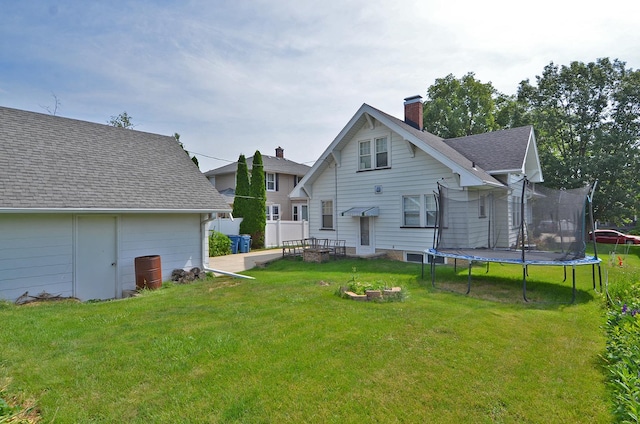 623 Marcy St, Ottawa, IL 61350 - back of property with a trampoline, a chimney, and roof with shingles