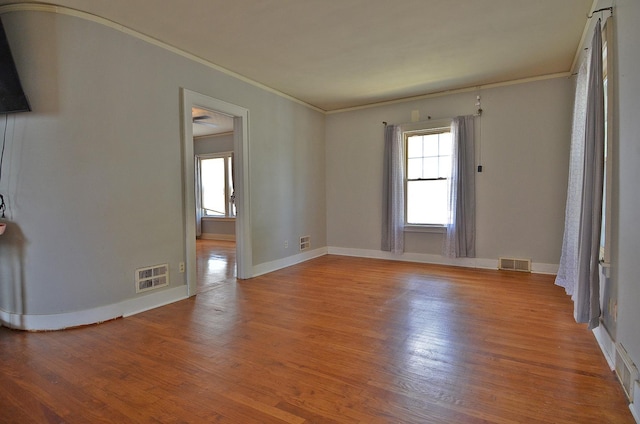 623 Marcy St, Ottawa, IL 61350 - empty room with crown molding, plenty of natural light, and wood finished floors