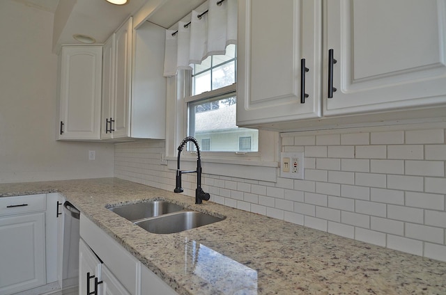 623 Marcy St, Ottawa, IL 61350 - kitchen featuring white cabinetry, tasteful backsplash, light stone countertops, and stainless steel dishwasher