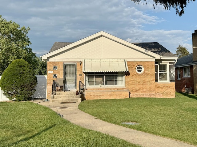 6349 N Olcott Ave, Chicago, IL 60631 - view of front of home featuring brick siding, a front yard, and roof with shingles