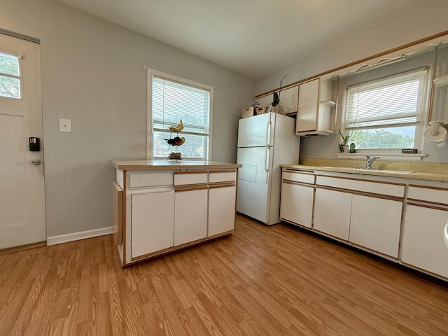 6349 N Olcott Ave, Chicago, IL 60631 - kitchen featuring freestanding refrigerator, light wood-style flooring, white cabinets, and light countertops