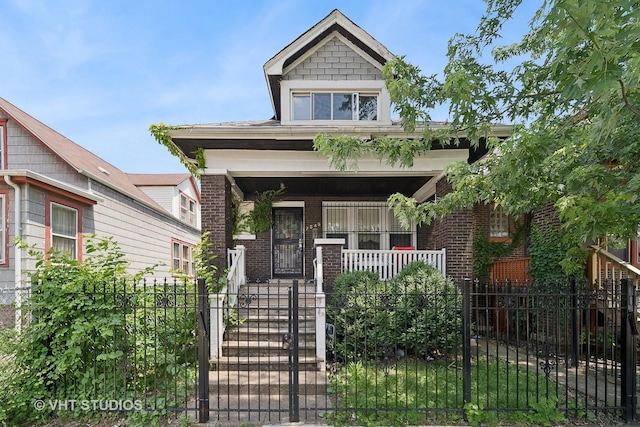 7545 S Rhodes Ave, Chicago, IL 60619 - view of front of property with a porch, a fenced front yard, brick siding, and a gate