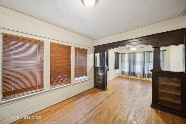 7545 S Rhodes Ave, Chicago, IL 60619 - spare room with hardwood / wood-style flooring, crown molding, arched walkways, and a ceiling fan