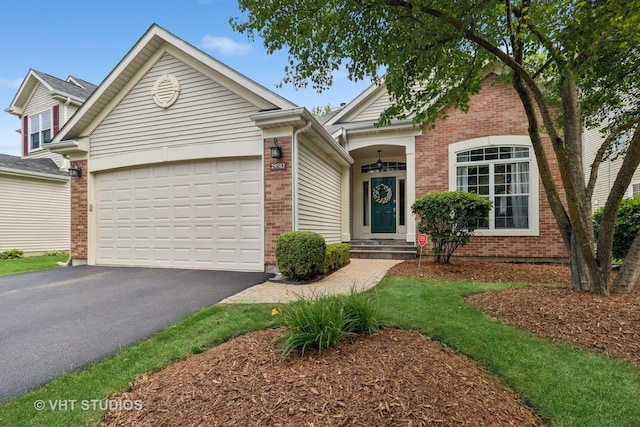 29583 N Birch Ave, Lake Bluff, IL 60044 - view of front of house with asphalt driveway, a garage, and brick siding
