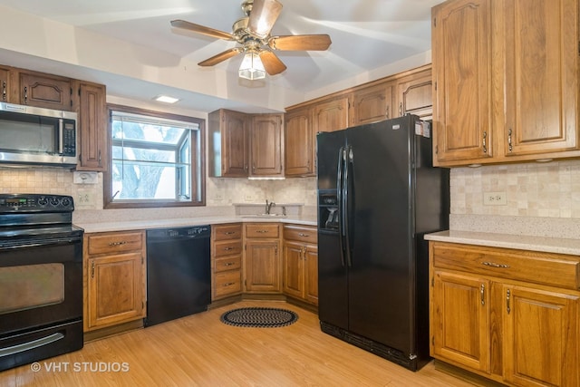 1406 Evans Ct, Elk Grove Village, IL 60007 - kitchen featuring black appliances, tasteful backsplash, and brown cabinets