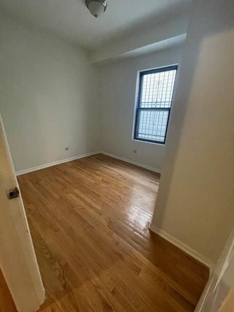 2620 W 24th St, Chicago, IL 60608 - spare room featuring wood finished floors and baseboards