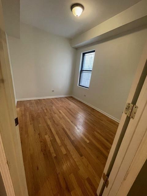 2620 W 24th St, Chicago, IL 60608 - spare room featuring wood finished floors
