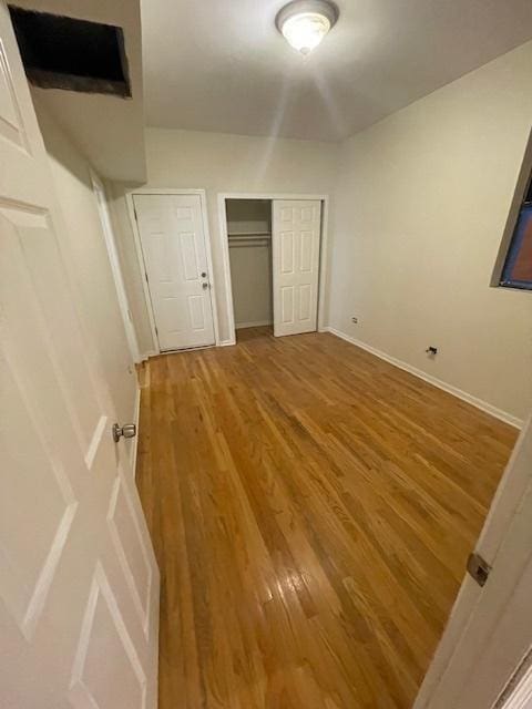 2620 W 24th St, Chicago, IL 60608 - unfurnished bedroom featuring wood finished floors and a closet