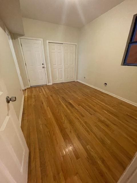 2620 W 24th St, Chicago, IL 60608 - unfurnished bedroom featuring wood finished floors and a closet