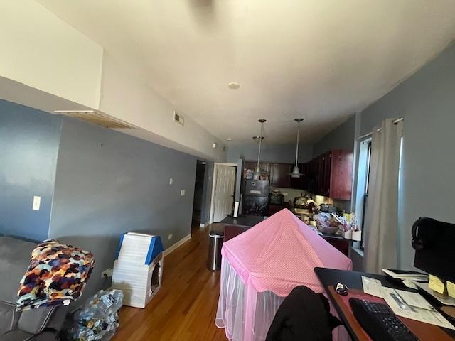 2620 W 24th St, Chicago, IL 60608 - kitchen with wood finished floors, refrigerator, and hanging light fixtures
