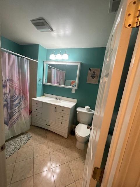 2620 W 24th St, Chicago, IL 60608 - full bathroom featuring vanity, tile patterned flooring, and a shower with shower curtain
