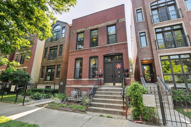1624 N Oakley Ave, Chicago, IL 60647 - view of property with brick siding and a fenced front yard