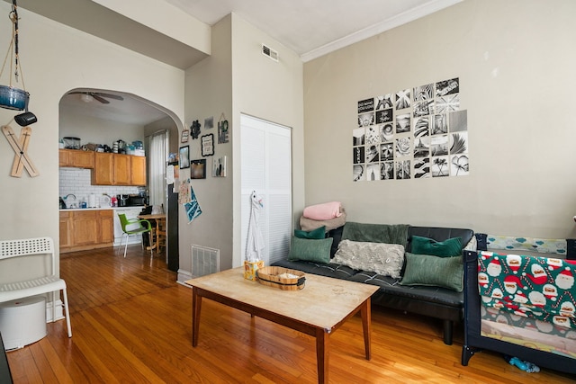 1624 N Oakley Ave, Chicago, IL 60647 - living area featuring hardwood / wood-style floors, arched walkways, and crown molding