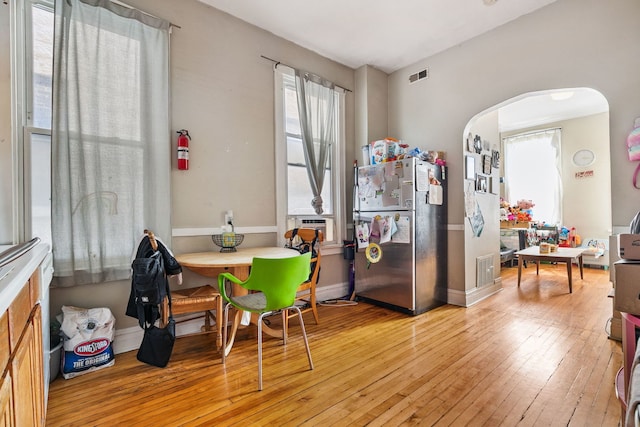 1624 N Oakley Ave, Chicago, IL 60647 - dining room featuring arched walkways, hardwood / wood-style floors, and cooling unit
