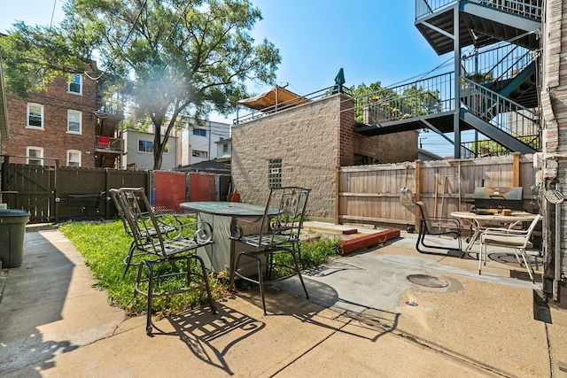 1624 N Oakley Ave, Chicago, IL 60647 - fenced backyard featuring a patio area, outdoor dining space, and stairway