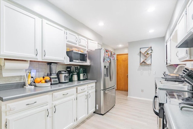 1311 Bancroft Dr, Bloomington, IL 61704 - kitchen featuring stainless steel appliances, white cabinets, backsplash, light wood-style flooring, and recessed lighting