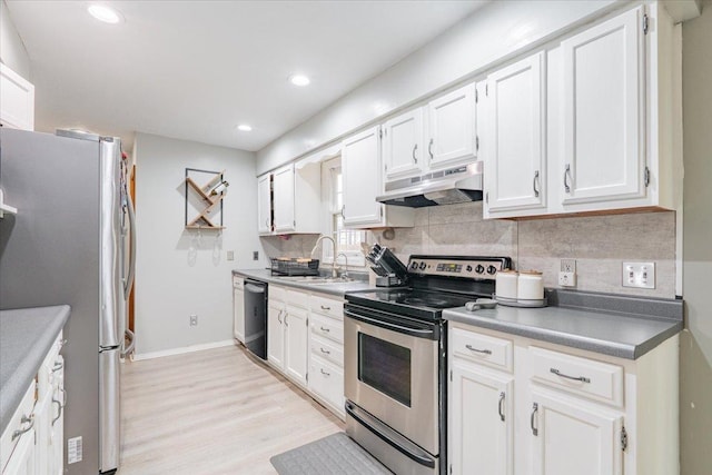 1311 Bancroft Dr, Bloomington, IL 61704 - kitchen featuring stainless steel appliances, under cabinet range hood, decorative backsplash, white cabinets, and light wood finished floors