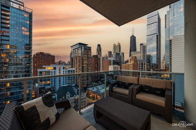 110 W Superior St Unit 1803, Chicago, IL 60654 - balcony at dusk featuring a skyline view and an outdoor hangout area