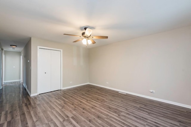 2302 Gilead Ave, Zion, IL 60099 - unfurnished bedroom with dark wood-type flooring, a closet, and a ceiling fan