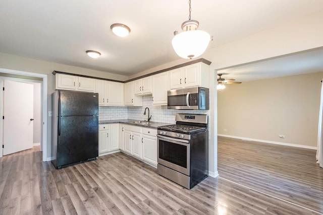 2302 Gilead Ave, Zion, IL 60099 - kitchen with appliances with stainless steel finishes, ceiling fan, light wood-style flooring, tasteful backsplash, and white cabinetry