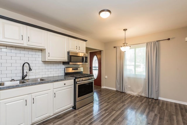 2302 Gilead Ave, Zion, IL 60099 - kitchen with stainless steel appliances, decorative backsplash, white cabinets, and dark wood-type flooring