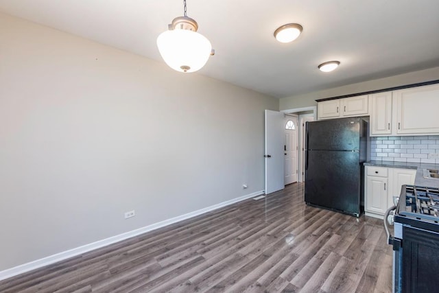 2302 Gilead Ave, Zion, IL 60099 - kitchen with freestanding refrigerator, stainless steel range with gas cooktop, wood finished floors, white cabinets, and decorative backsplash