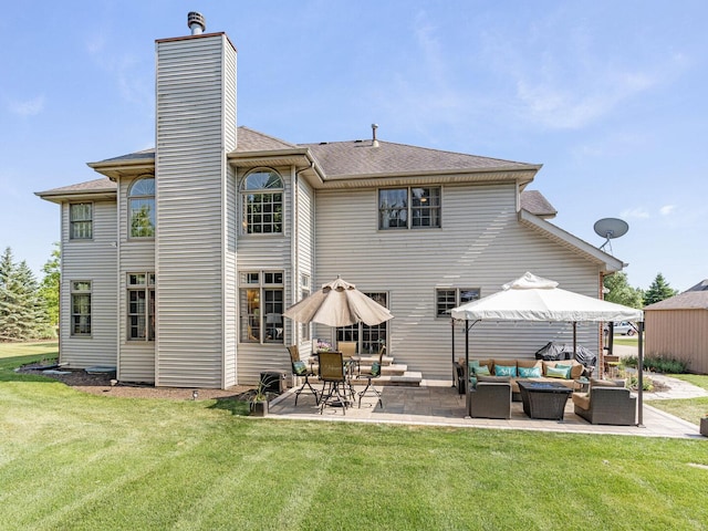 12114 W Castle Dr, Mokena, IL 60448 - rear view of property featuring an outdoor hangout area, a patio, a yard, roof with shingles, and a chimney
