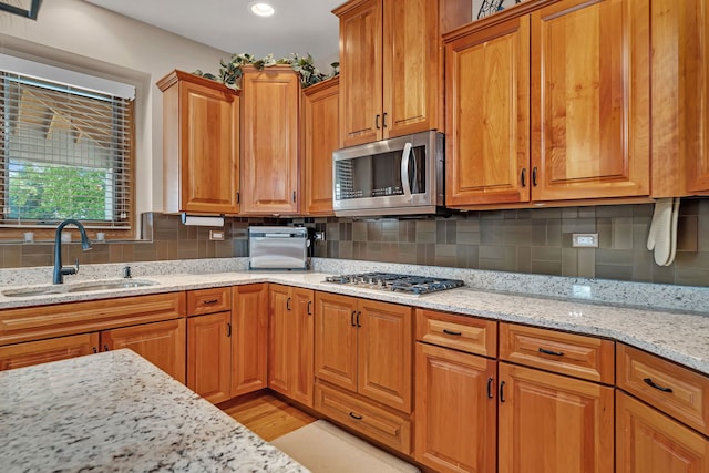 26645 W Ian Ct, Channahon, IL 60410 - kitchen with stainless steel appliances, light stone countertops, backsplash, brown cabinets, and recessed lighting