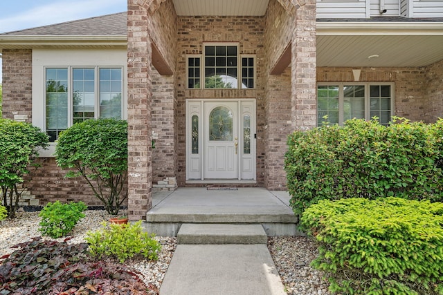 26645 W Ian Ct, Channahon, IL 60410 - doorway to property with a shingled roof, a porch, and brick siding