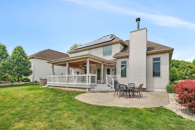 26645 W Ian Ct, Channahon, IL 60410 - back of property featuring ceiling fan, solar panels, a patio, a lawn, and a chimney