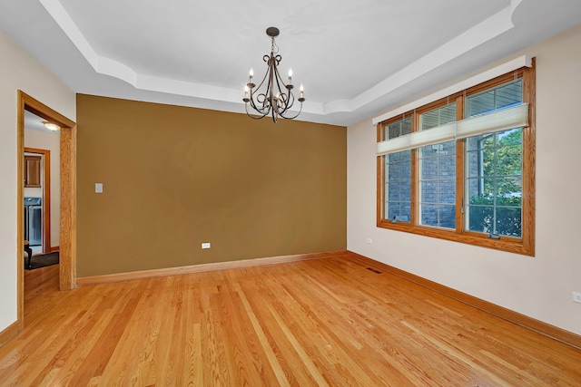 26645 W Ian Ct, Channahon, IL 60410 - unfurnished room featuring a tray ceiling, a chandelier, and light wood-style flooring