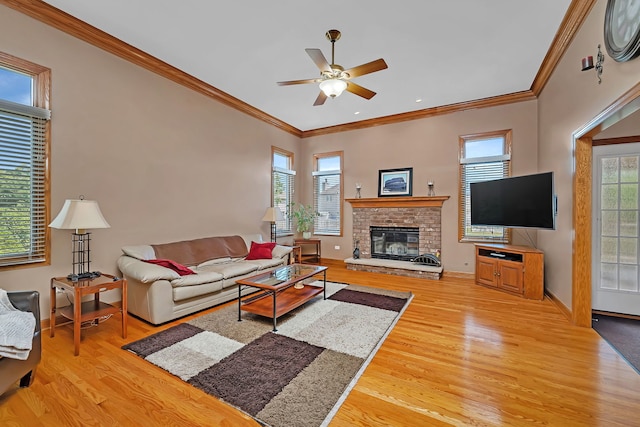 26645 W Ian Ct, Channahon, IL 60410 - living area with light wood-style flooring, ceiling fan, ornamental molding, and a fireplace