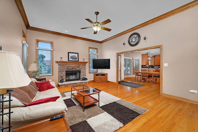 26645 W Ian Ct, Channahon, IL 60410 - living room featuring crown molding, wood finished floors, a ceiling fan, and a brick fireplace