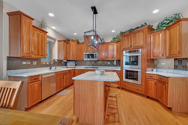 26645 W Ian Ct, Channahon, IL 60410 - kitchen featuring stainless steel appliances, light wood-type flooring, tasteful backsplash, brown cabinets, and recessed lighting