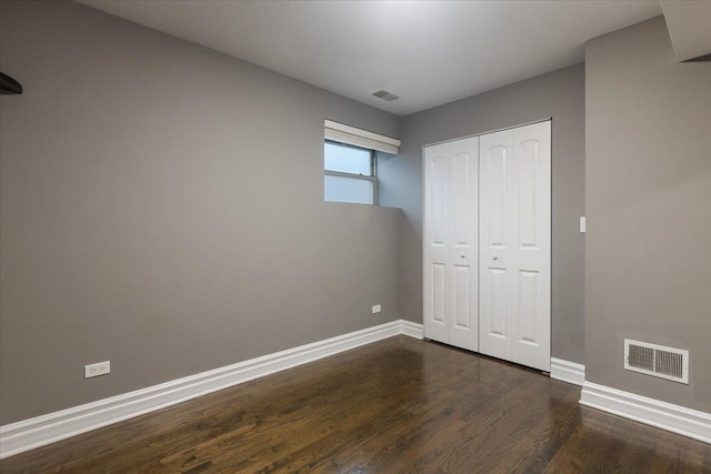 4351 S Forrestville Ave Unit G, Chicago, IL 60653 - unfurnished bedroom featuring dark wood-type flooring and a closet