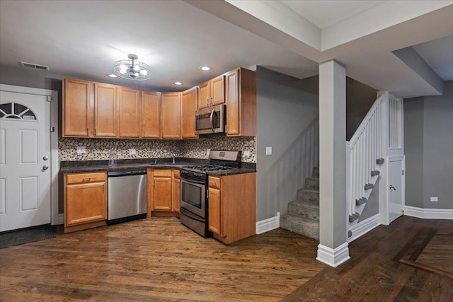 4351 S Forrestville Ave Unit G, Chicago, IL 60653 - kitchen with appliances with stainless steel finishes, dark wood finished floors, backsplash, dark countertops, and recessed lighting