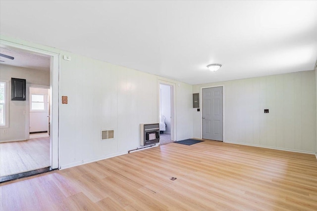 323 N 2nd Ave, Chenoa, IL 61726 - unfurnished living room featuring wood finished floors and heating unit