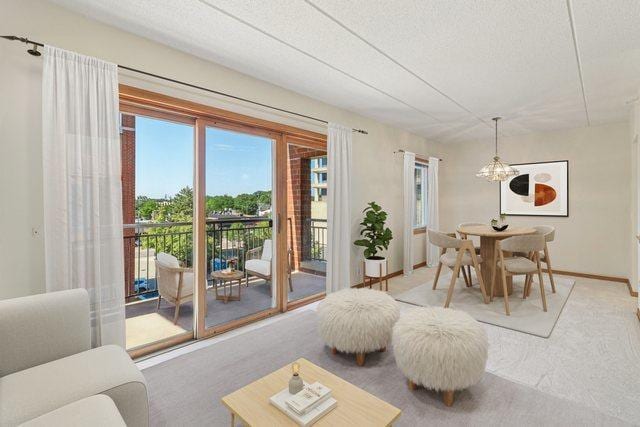 5005 Warren St Unit 403, Skokie, IL 60077 - living area featuring carpet floors, a textured ceiling, and a chandelier