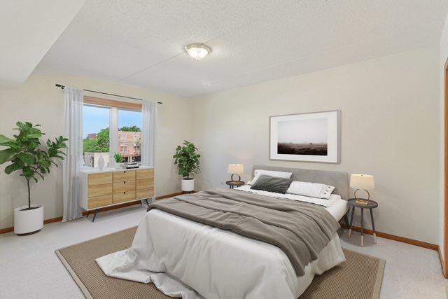 5005 Warren St Unit 403, Skokie, IL 60077 - bedroom with light carpet and a textured ceiling