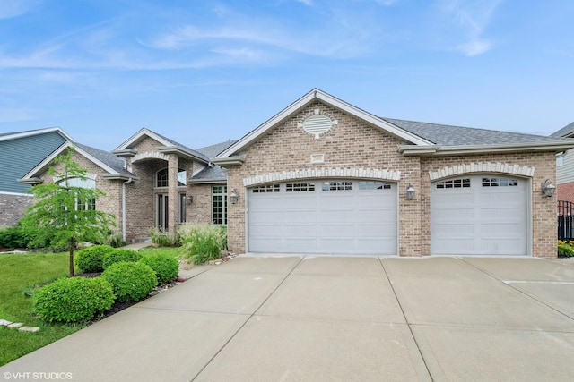 21409 Foxtail Dr, Mokena, IL 60448 - view of front of home with driveway, an attached garage, brick siding, and a shingled roof