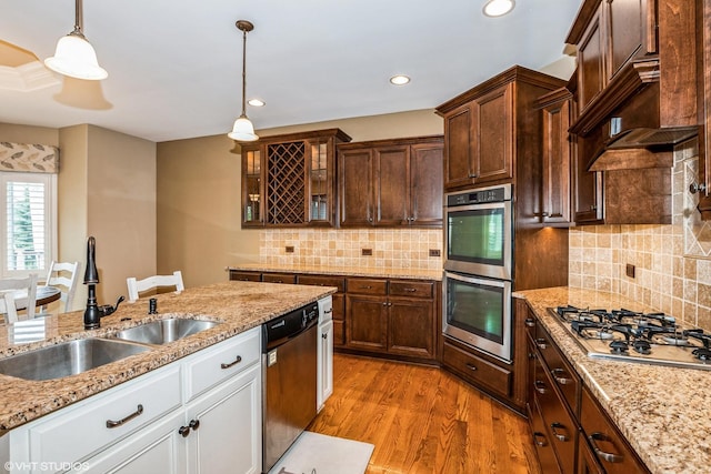 21409 Foxtail Dr, Mokena, IL 60448 - kitchen with appliances with stainless steel finishes, glass insert cabinets, light wood-type flooring, pendant lighting, and white cabinets