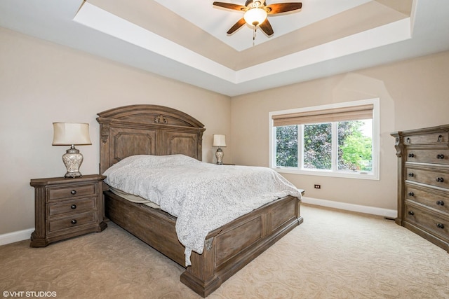 21409 Foxtail Dr, Mokena, IL 60448 - bedroom featuring light carpet, a tray ceiling, and a ceiling fan