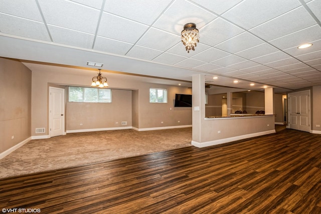 21409 Foxtail Dr, Mokena, IL 60448 - unfurnished living room featuring dark wood-style flooring, a drop ceiling, recessed lighting, and a chandelier